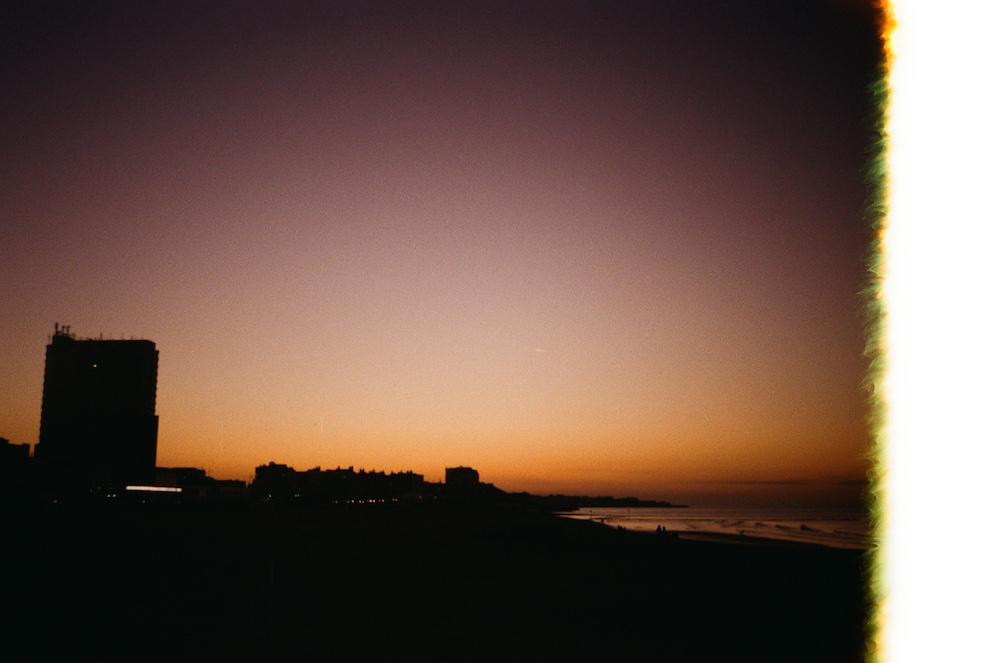 half-burnt film photo at the beginning of the roll showing a dark reddish beach in market