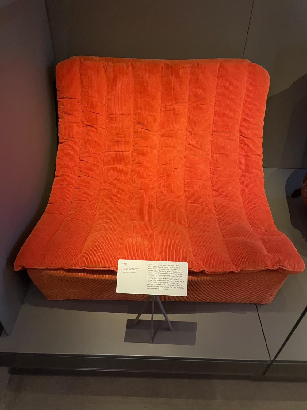 the scoop chair,  a wide curving shape in bright orange