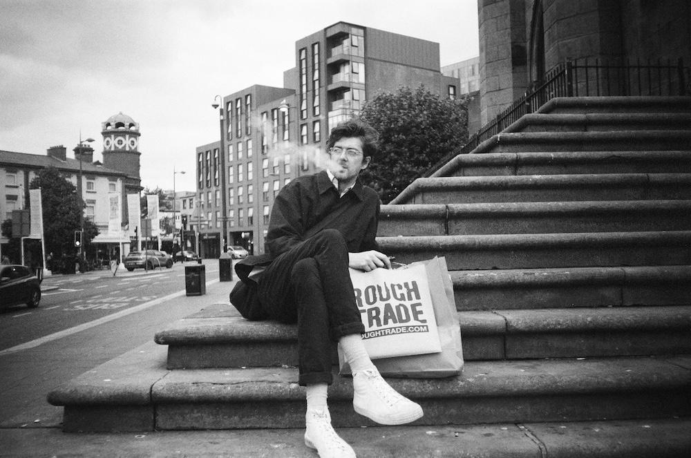 michael vaping on the steps of the bombed out church