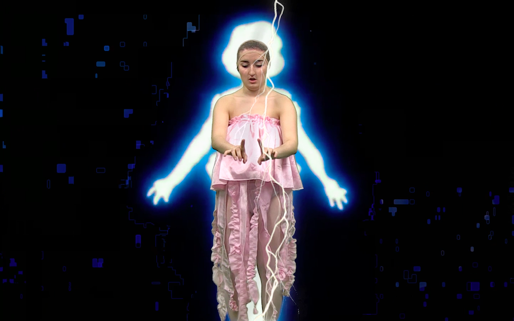 Gab is dressed with a hair net on and a pale pink silky top with floaty pieces at the bottom, like a jellyfish, and behind her there is a blue black white digital outline of a magic girl, and over top there is digital lightning that she looks like she is controlling with her hands
