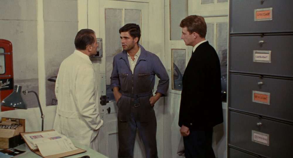 nino at work in the garage with blue overalls on