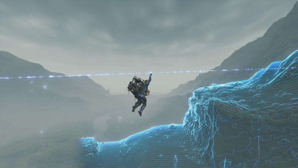 Sam zooms across a mountainous region on a blue zipline that looks impossible, made of light, while he scans the earth below him that shows the topography with the same look in rows and rows of blue lines