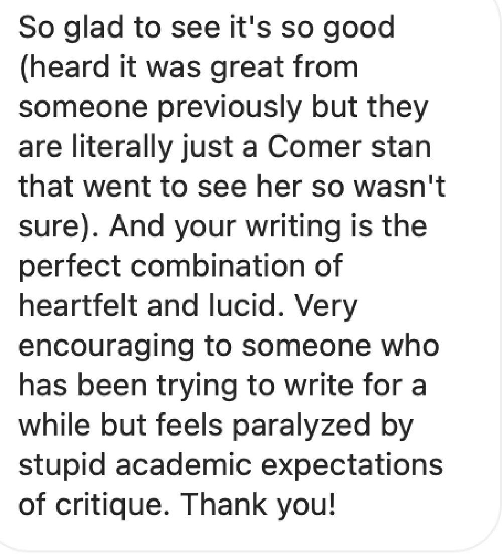 two people on a bridge look up at a huge scary grinning figure which has a bandaged face and one green eye visible