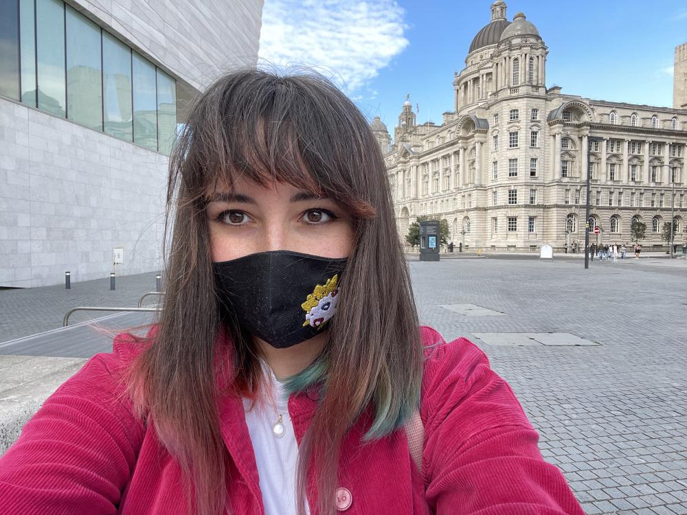 gab outside the museum of liverpool with a togepi facemask on