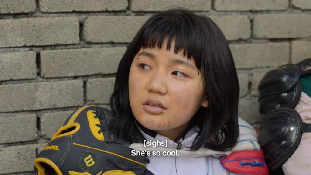 lee eun-saem looks off camera, little marks of blood on her face from the last fight, sighs and says she's so cool as she looks at the archer who is protecting her