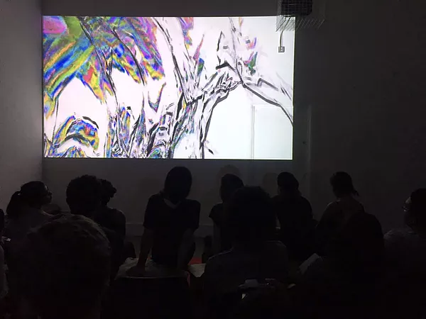 a shot of the audio watching the showreel in a big room