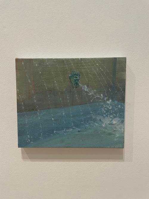 a lion head fountain piece spewing water