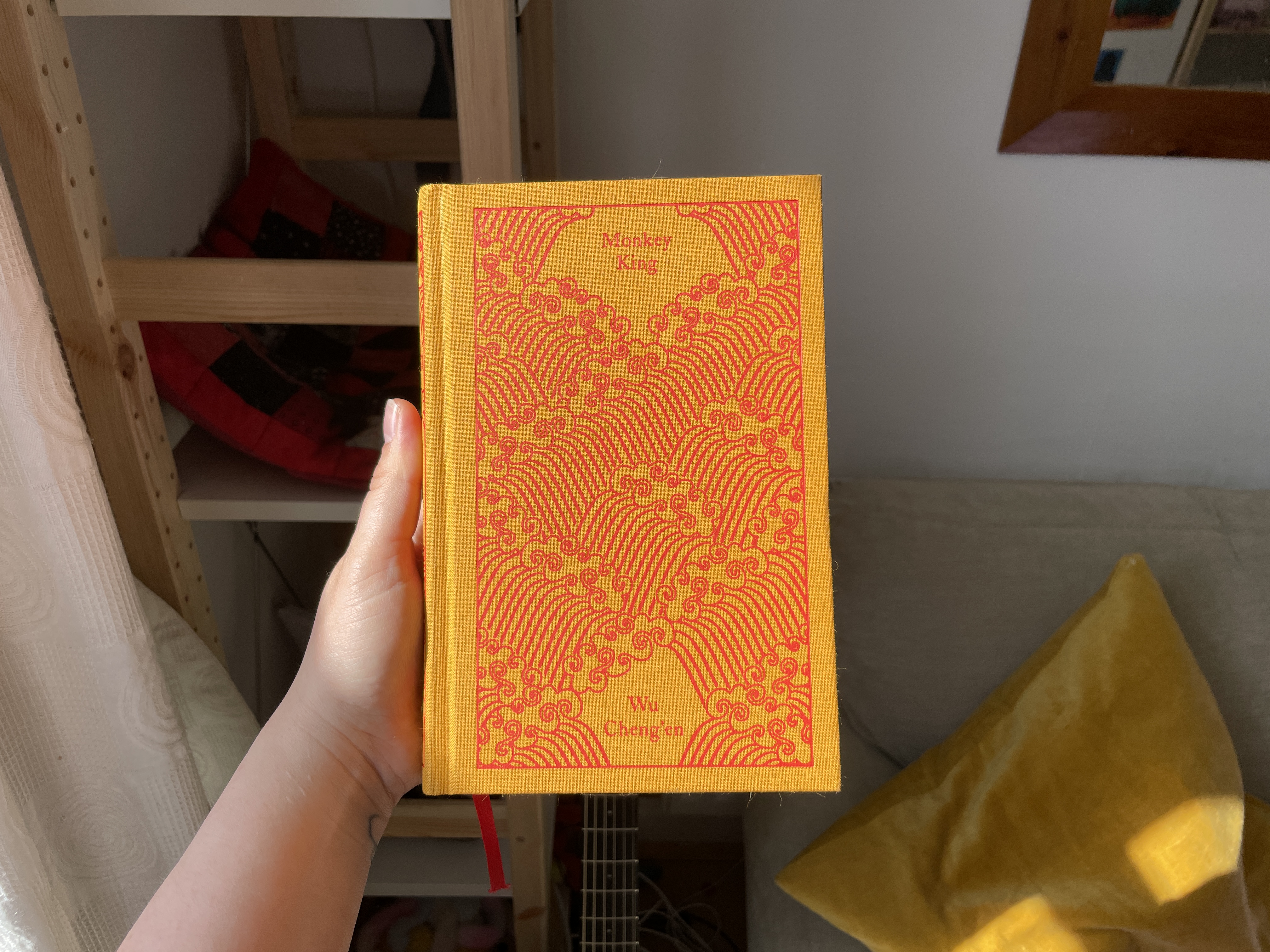 the penguin classics edition of monkey king with a gold orange cover and red detailing of waves
