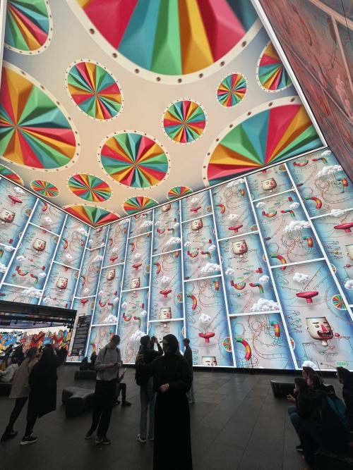 colourful wheels and different chain reaction animations on the screens at outernet