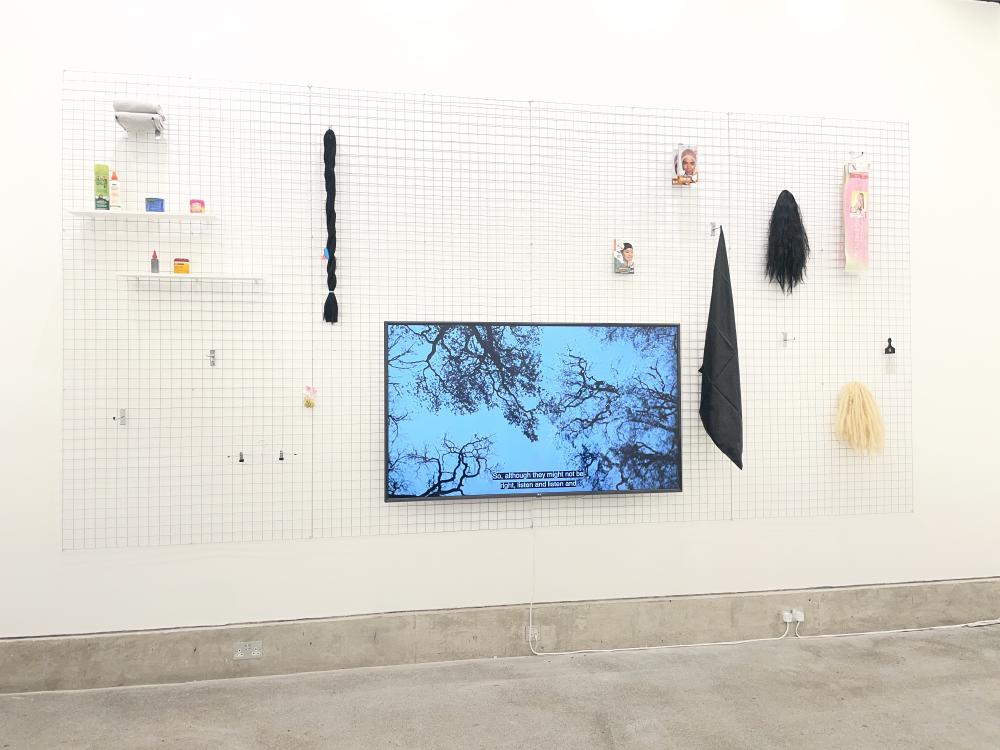 a view onto the other table showing some red and white circles of fabric stitched together