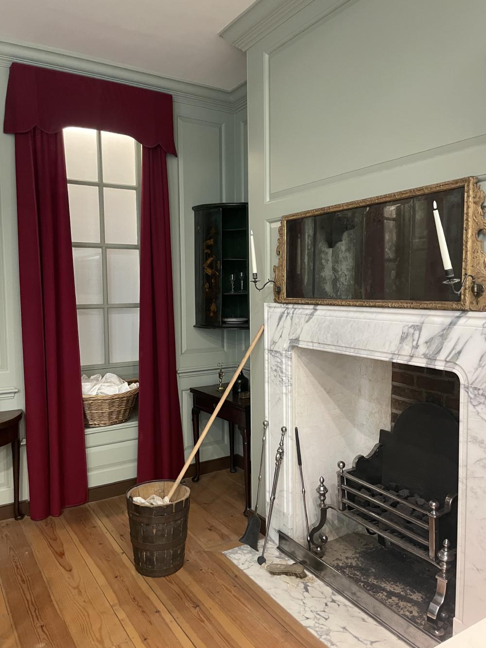 an old parlour recreated with details including a mop bucket showing the cleaner has been busy preparing the house for the middle class family